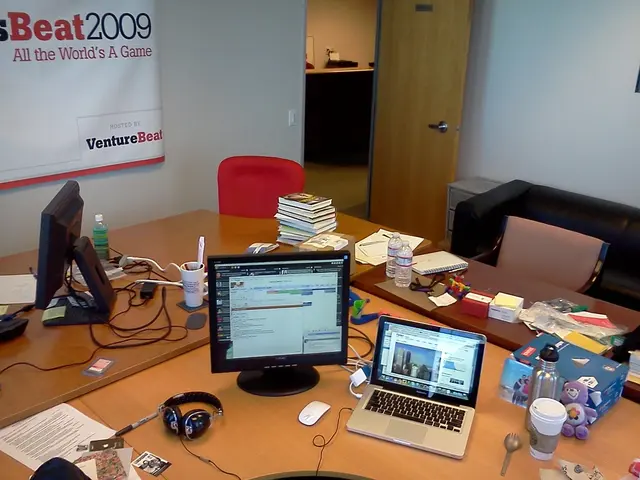 As we can see in the image there is a white color wall, door, banner, sofa and table. On table...