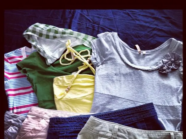 In the picture I can see clothes which are in grey, yellow, green, and blue color line T-shirts and...