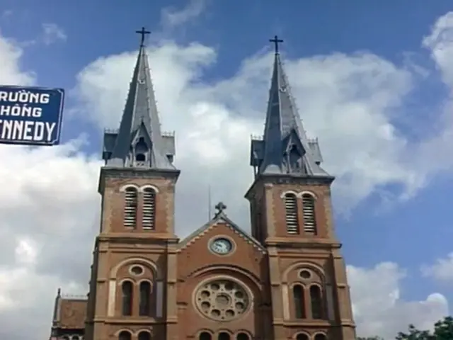 In this image there is a church building in middle of this image. There is a tree in the bottom...