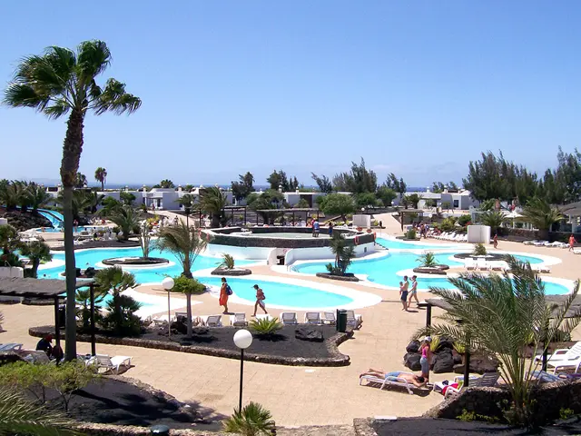 In the image it seems to be a resort, there are pools in the middle with trees all around the place...