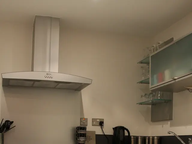 In this image we can see kitchen platform with drawers, oven and a handle. On the handle there is...